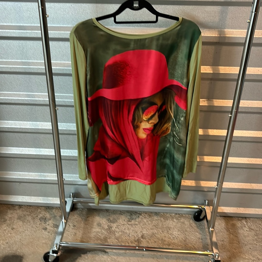 Very unusual top of a woman in a red hat/scarf. Base color is green. NWOT
